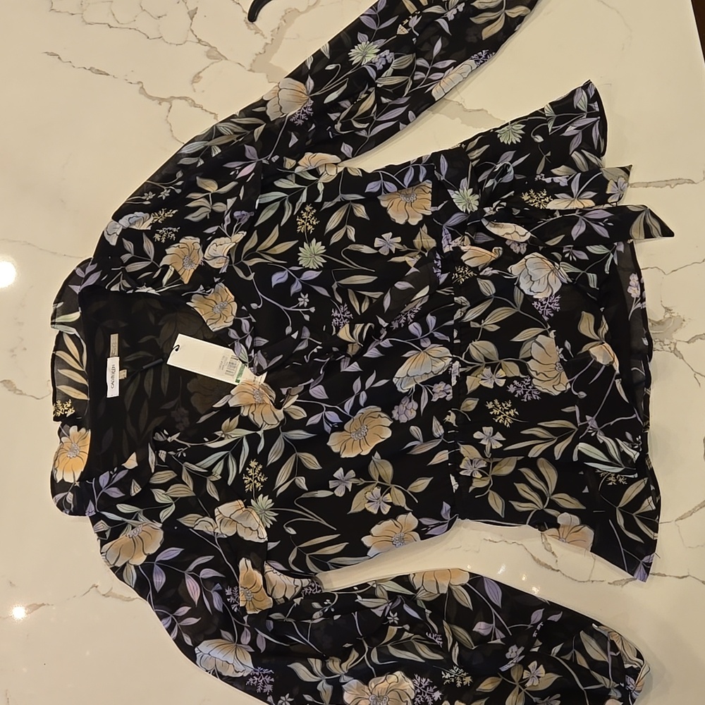 NEW.. sheer floral blouse with side tie. Ruffle neck and ruffles flow down sleev